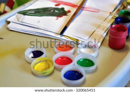 Beautiful view of paints and wooden brush