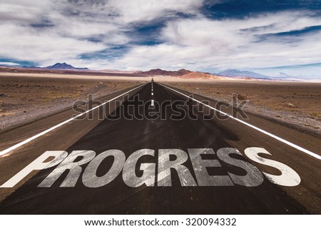 Progress written on desert road