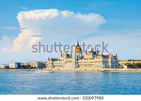 Parliament building in Budapest, Hungary on a bright sunny day with passenger ship. This picture is toned.