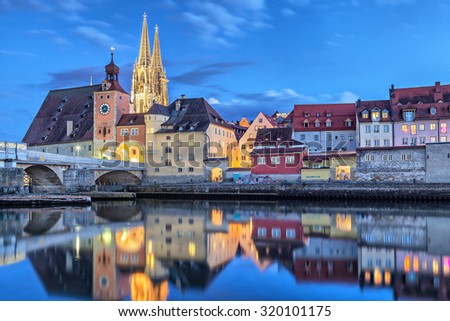 Historical Stone Bridge, Bridge tower and buildings in the evening, Regensburg, Germany Royalty-Free Stock Photo #320101175