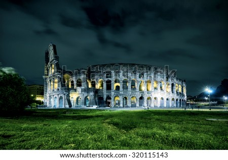 Colosseum or Coliseum at night, Rome, Italy, Europe. Ancient Roman Colosseum is top landmark of Rome. Night view of Colisseum in lights. Concept of haunted place, old house, Halloween, travel, Roma. Royalty-Free Stock Photo #320115143