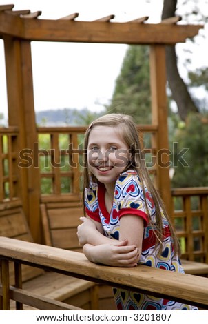 beautiful young girl on cedar deck