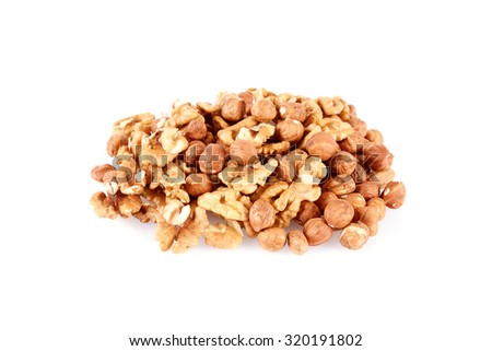Pile of walnut kernels and peeled hazelnuts isolated on white