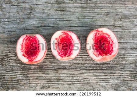 Red peaches on a grey retro wooden background