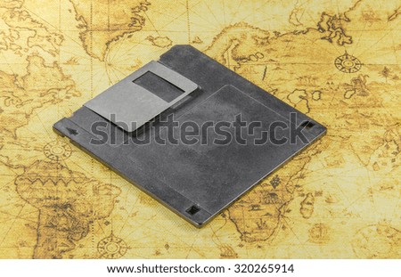 dirty floppy disk on a old world map