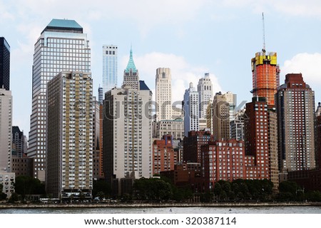 Manhattan skyline panorama over Hudson River, NYC. Midtown view with big skyscrapers, New York City, USA. Top of the buildings in financial district. Business background. NY skyscrapers.