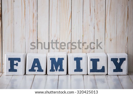 A portrait of FAMILY sign made of wooden blocks on wooden background