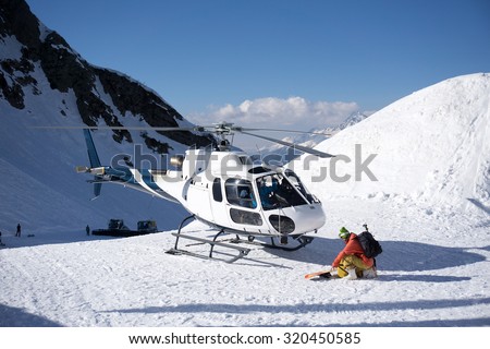 White rescue helicopter parked in the snowy mountains Royalty-Free Stock Photo #320450585