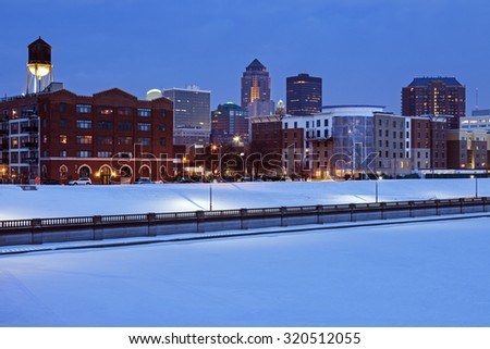 Des Moines skyline across frozen river. Des Moines, Iowa, USA.