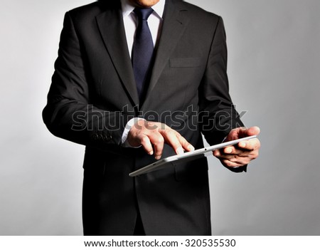 Businessman holds a table pc