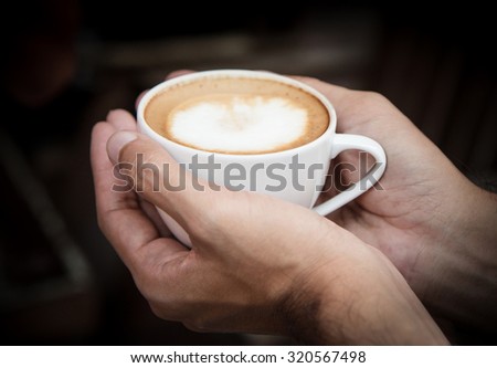 Man holding hot cup of coffee