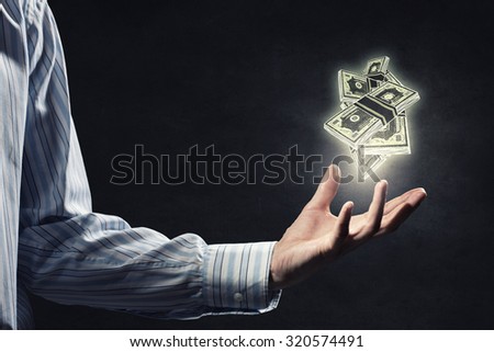 Close up of male hand holding dollar banknotes