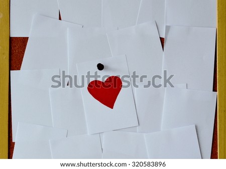 red heart paper note on noticeboard