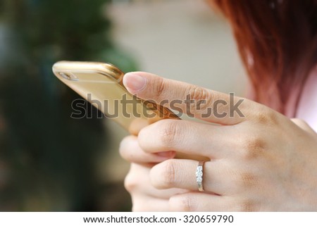  woman hand with phone ,using mobile smart phone, Internet of things lifestyle with wireless communication and internet with smartphone.