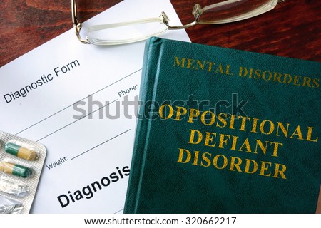 Oppositional defiant disorder  concept. Diagnostic form and book on a table. Royalty-Free Stock Photo #320662217