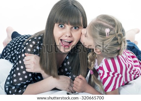 Little girl blonde mother kisses