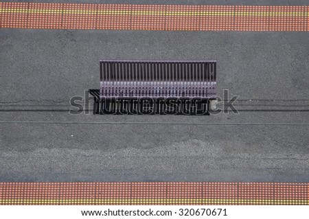 Top perspective view of a bench near  to  railway track line