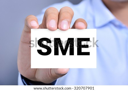 SME letters (or Small and Medium-sized  Enterprises) on the card shown by a man