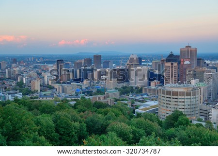 Montreal city skyline at sunset viewed from Mont Royal with urban skyscrapers.