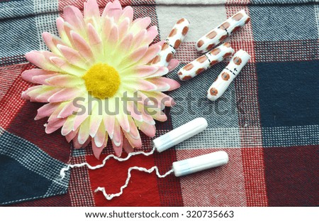 Woman hygiene protection, close-up.menstruation calendar with cotton tampons,daisy