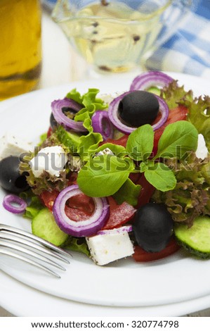 Greek salad in a plate on the table