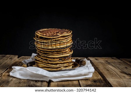 Big homemade pancakes, black background, place for your advertising or text