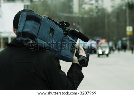 news reporter (special toned photo f/x, focus point on camcorder (selective)