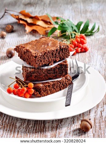 Chocolate brownies, cake or chocolate squares, Thanksgiving or autumn table setting. Selective focus.