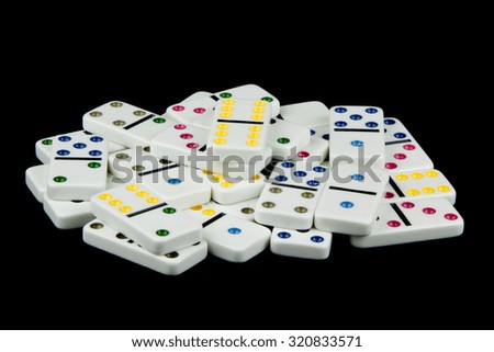 White domino tiles piled randomly against a black background