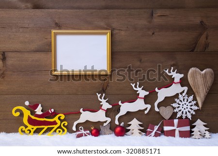 Christmas Decoration, Red Santa Claus, Yellow Sled And Reindeer On White Snow. Gift, Present, Christmas Tree, Ball, Snowflakes, Heart, Picture Frame. Brown Rustic Vintage Wooden Background, Copy Space