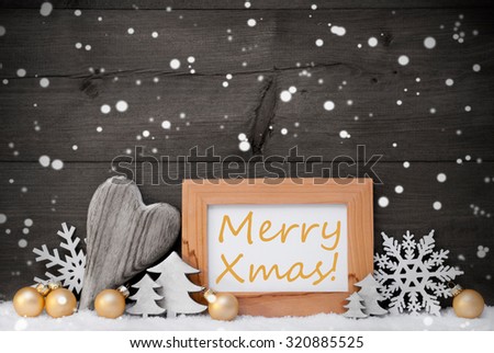 Golden Christmas Decoration On Snow. Heart, Christmas Tree Balls, Snowflakes, Christmas Tree. Picture Frame With English Text Merry Xmas. Rustic, Vintage Gray Wooden Background. Black And Withe Image
