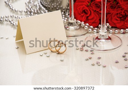Wedding rings with writing card and champagne, copyspace