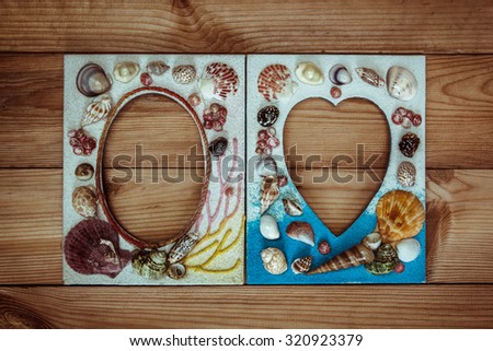Picture frame made from sea shell on wood wall.