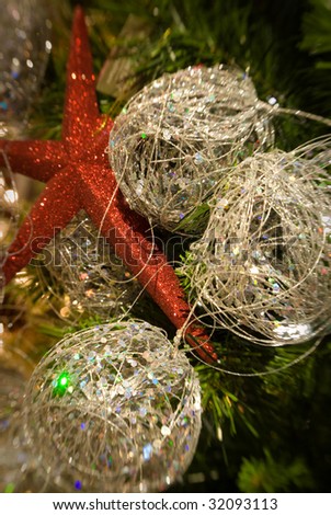 red star and gold balls in a holiday tree with shallow depth of field