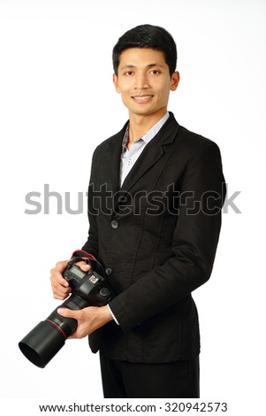 Portrait of young photographer in suit with a camera.