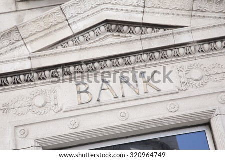 Bank Sign on White Building Facade