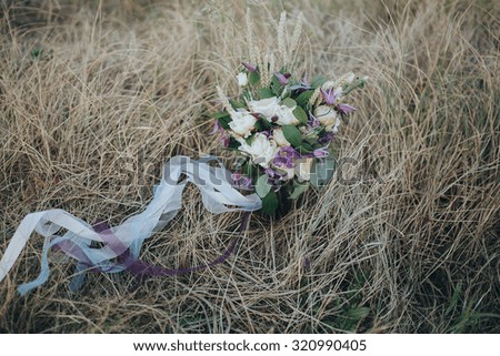 bouquet of flowers and greens lying on the grass