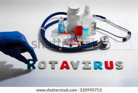 Diagnosis - Rotavirus. Medical concept with pills, injection, stethoscope, cardiogram and a syringe Royalty-Free Stock Photo #320990753