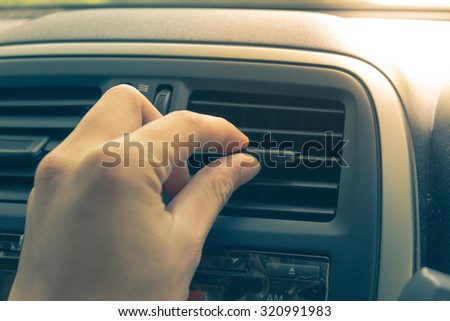 Vintage old image of man hand turn signal switch. Car interior detail.