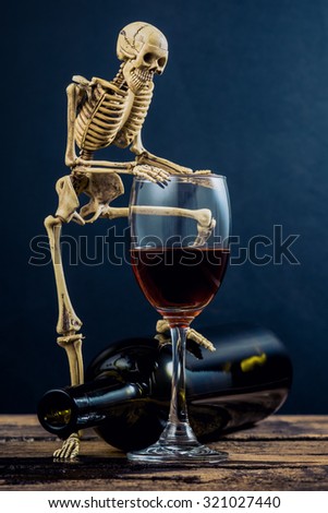 still life photography : drunkard human skeleton with wine glass and bottle