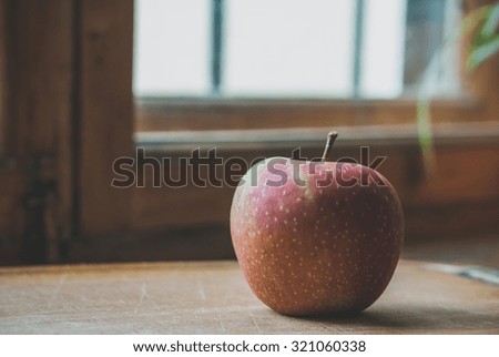 A red apple on a window