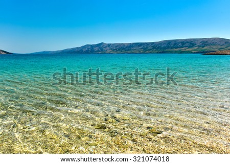 Beach in the coast of Adriatic Sea  island Pag or Hvar.  Turquoise and blue sea water of Adriatic and Mediterranean sea. Beautiful background landscape photo with calm sea water and blue skies.