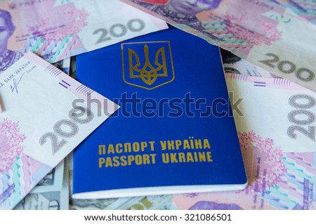 Ukraine traveling passport with dollar bills