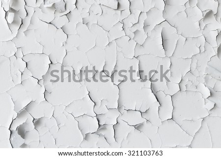 Cracked flaking white paint on the wall, background texture Royalty-Free Stock Photo #321103763
