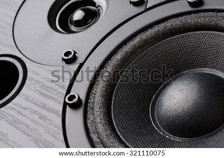 Multimedia speaker system with different speakers closeup over black background Royalty-Free Stock Photo #321110075