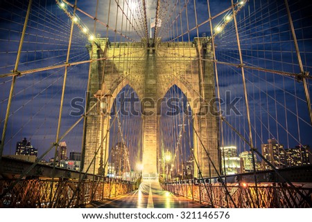 Beautiful Brooklyn Bridge in New York City seen at night from the pedestrian walkway