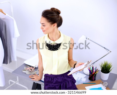 Modern young fashion designer working at studio.