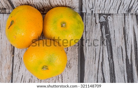 Yellow tangerine fruit over wooden background