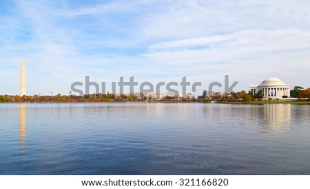 Washington Monument and Thomas Jefferson Memorial in the Fall. Panoramic view of the Tidal Basin with major national capital attractions surrounded by the colorful tree foliage in the Fall.