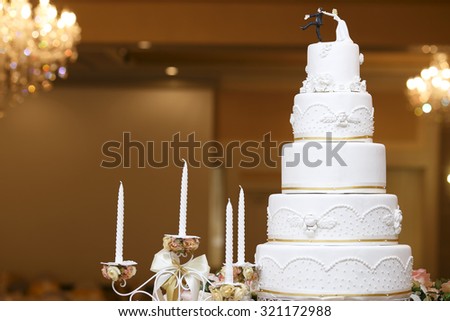 wedding bride and groom couple doll in funny action on wedding cake